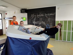 Uczniowie z grupy żeglarskiej korzystają z symulatora żeglarskiego.