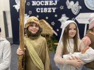 Dwóch uczniów - aktorów zespołu teatralnego "Świetliki" prezentuje się do zdjęcia podczas przedstawienia teatralnego "Jasełka".